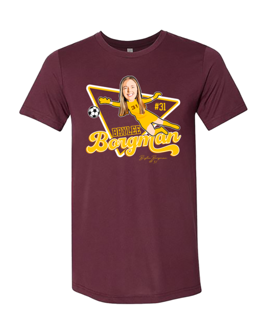 A maroon t-shirt with a picture of a person on it.